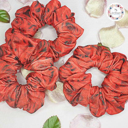 Add a touch of boldness to your hair with our Red and Black Roses Scrunchie! Handmade by myluxeoccasion, this scrunchie guarantees no wilted flowers. 